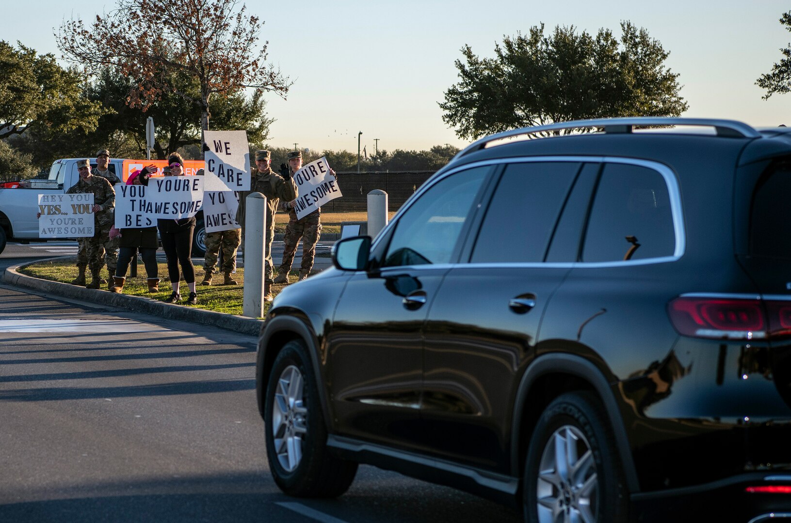 37th Training Wing military and civilian members hold positive messages of support at base gates during the morning inbound commute as part of their new initiative, “We Care,” at Joint Base San Antonio-Lackland, Texas, Dec. 18, 2019. The initiative involved 37th Training Wing military and civilian members spending the morning at various gates letting each person know that they stand together in support of those struggling with depression and thoughts of suicide by holding a positive message of support and handing out over 400 candy canes. If you are struggling with thoughts of suicide, please go directly to the Mental Health Clinic or to your closest Emergency Room. You can also reach the National Suicide Prevention Lifeline at 1-800-273-8255.