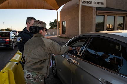 Staff Sgt. Monserat Bravo Ponce, Inter-American Air Forces Academy, hands out a candy cane during the morning inbound commute in support of the 37th Training Wing new initiative, “We Care,” at Joint Base San Antonio-Lackland, Texas, Dec. 18, 2019. The initiative involved 37th Training Wing military and civilian members spending the morning at various gates letting each person know that they stand together in support of those struggling with depression and thoughts of suicide by holding a positive message of support and handing out over 400 candy canes. If you are struggling with thoughts of suicide, please go directly to the Mental Health Clinic or to your closest Emergency Room. You can also reach the National Suicide Prevention Lifeline at 1-800-273-8255.