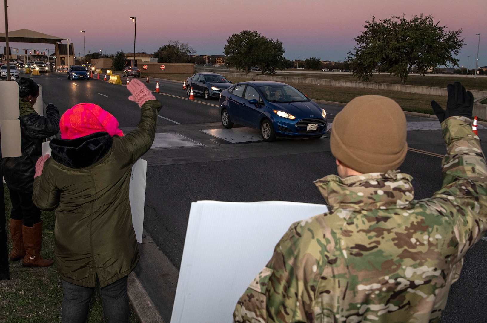 37th Training Wing military and civilian members hold positive messages of support at base gates during the morning inbound commute as part of their new initiative, “We Care,” at Joint Base San Antonio-Lackland, Texas, Dec. 18, 2019. The initiative involved 37th Training Wing military and civilian members spending the morning at various gates letting each person know that they stand together in support of those struggling with depression and thoughts of suicide by holding a positive message of support and handing out over 400 candy canes. If you are struggling with thoughts of suicide, please go directly to the Mental Health Clinic or to your closest Emergency Room. You can also reach the National Suicide Prevention Lifeline at 1-800-273-8255.