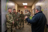 633rd Air Base Wing Commander U.S. Air Force Col. Clinton Ross, U.S. Air Force Command Chief Master Sgt. Greg Peterson, 733rd Mission Support Group Commander U.S. Army Col. Jennifer Walkawicz, and Command Sgt. Maj. Abby Macdonald are briefed by Joint Task Force Civil Support’s Deputy Director of Operations Kenneth Lucas on the command’s new chemical, biological, radiological and nuclear wall of knowledge during their tour of Joint Task Force Civil Support (JTF-CS) headquarters. The brief was a part of 633rd and 733rd leadership’s visit to JTF-CS. The visit also included a command mission and operations brief with the JTF-CS leadership. (Official DoD photo by Mass Communication Specialist 3rd Class Michael Redd/RELEASED)