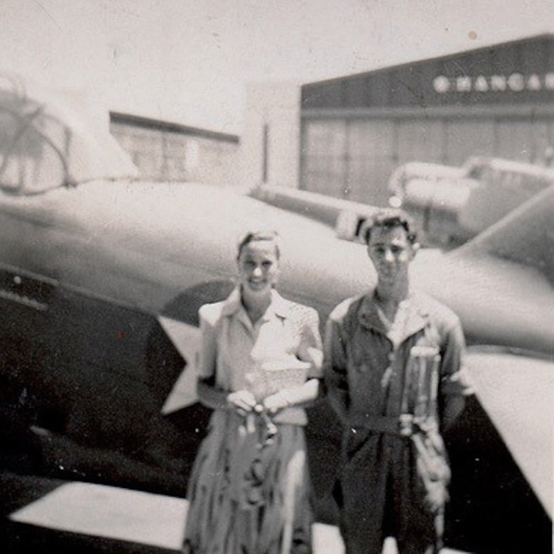 A man poses next to his girlfriend.