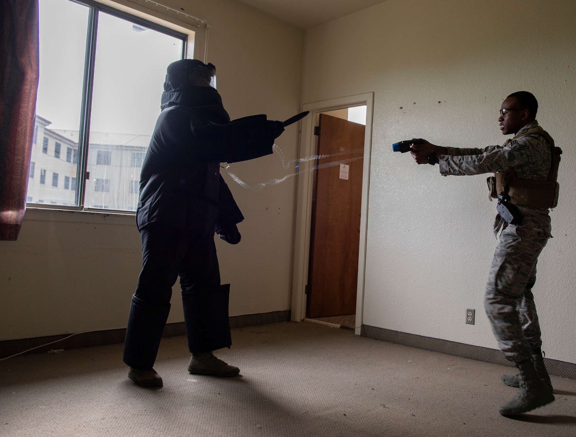 U.S. Air Force Senior Airman Rodreques Wright, right, 60th Security Forces Squadron Phoenix Raven, demonstrates tasing during a hostile force during the 60th Mission Support Group honorary commanders tour Dec. 6, 2019, at Travis Air Force Base, California. Travis AFB’s honorary commander program allows base leadership to develop relationships with local, civic and business leaders. It also gives the opportunity to learn about the surrounding communities. (U.S. Air Force photo by Senior Airman Jonathon Carnell)
