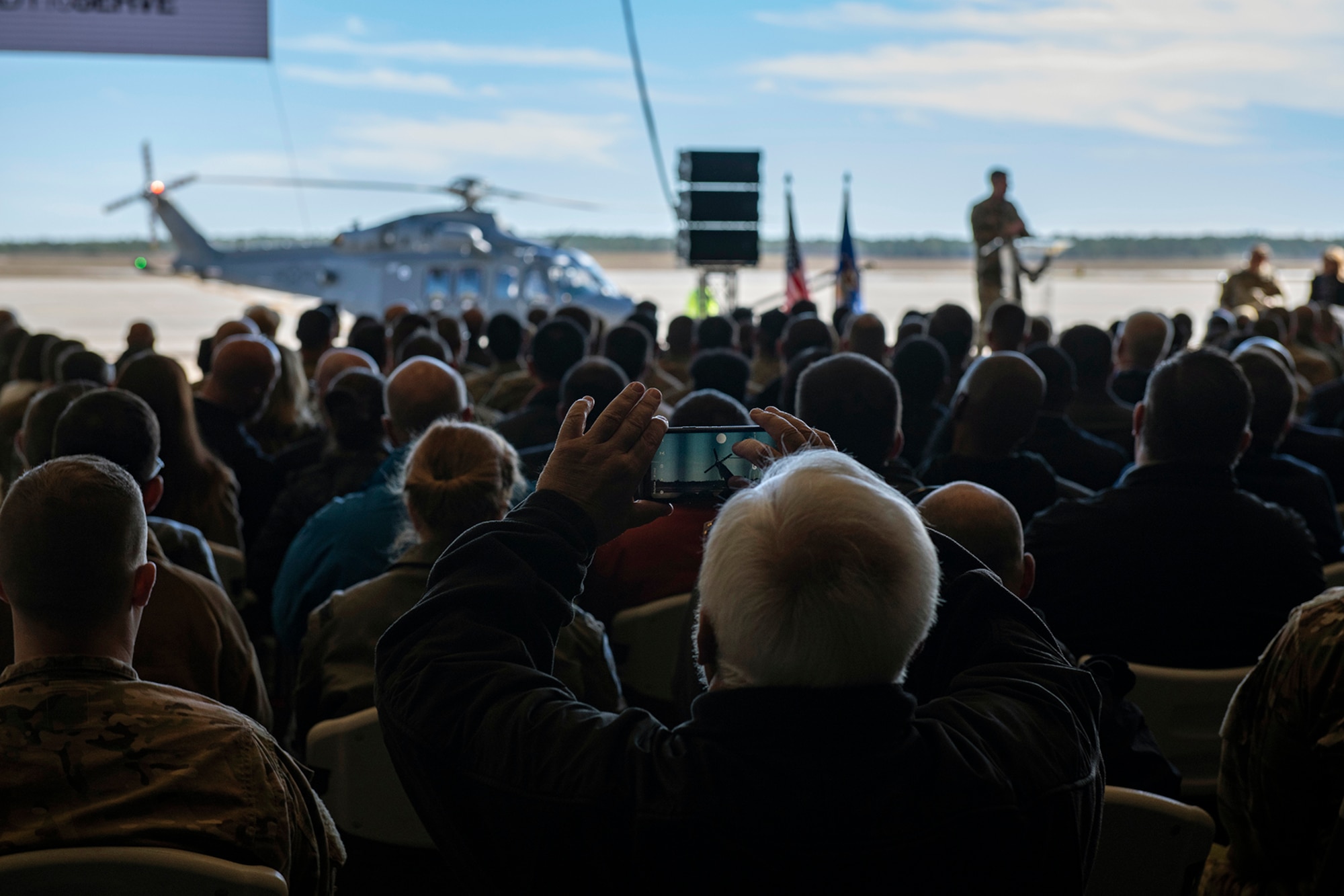 Man takes photo of aircraft with his phone.