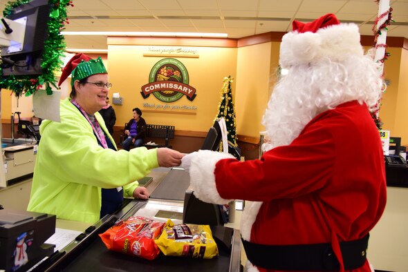 Sherri Johnshon, Commissary sales store checker, assists Santa Claus in the purchase of some candy from Laughlin’s commissary for the nice Airmen he meets during his pre-holiday visit to Laughlin Air Force Base, Texas on Dec. 17, 2019. “Your commissary offers the quality you expect and the deeper savings you deserve on all the items you will need for your holiday meals, going even further to extend your holiday spending,” said Tracie Russ, Defense Commissary Agency sales director. “And while you’re at it, use the money you’re saving to do your New Year’s dinner shopping as well – at the commissary.” (U.S. Air Force photo by Senior Airman Anne McCready)