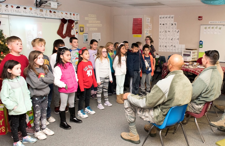A class of Ellicott Elementary School second graders gave Team Schriever Airmen a preview of the school’s upcoming winter concert during a visit to the school in Ellicott, Colorado, Dec. 18, 2019.