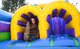 An airman plays in an inflatable obstacle course.