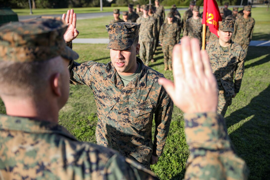 U.S. Marine Corps Staff Sgt. Jeffrey Cordero is sworn in by the Commanding Officer of 12th Marine Corps District, Colonel James B. Conway, during his reenlistment ceremony aboard Marine Corps Recruit Depot San Diego, Calif., on December 19, 2019. Nine years ago, then Corporal Jeffrey Cordero was sworn into the Marine Corps by Colonel Conway’s father, and 34th Commandant of the Marine Corps, General James T. Conway, during his reenlistment ceremony at the 9th Marine Corps District Headquarters in Kansas City, Mo., on Aug. 29, 2010. Staff Sgt. Jeffrey Cordero is the Communications Strategy and Operations Chief at 12th Marine Corps District, and is from New York City, N.Y. (U.S. Marine Corps photo by Sgt. Autmn Laning)