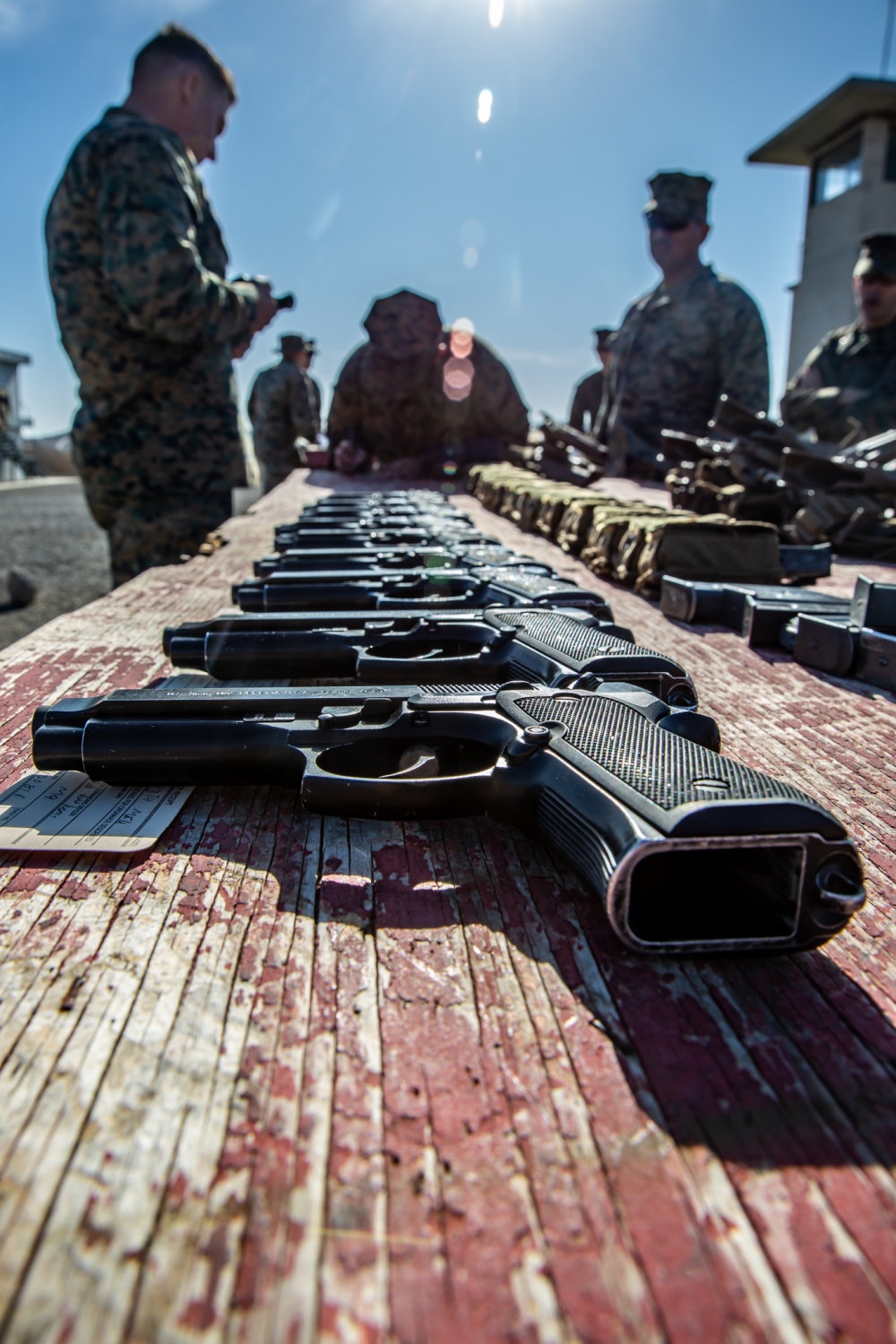 U.S. Marines with the 13th Marine Expeditionary Unit Command Element, await to be issued their M9 pistol before a pistol qualification range at Marine Corps Base Camp Pendleton, Nov. 26, 2019. The annual range test Marines on their marksmanship with a service pistol and qualifies them to stand duty in support of MEU operations. The California-based 13th MEU is scalable, and highly capable Marine Air-Ground Task Force, designed to rapidly respond to a wide range of military operations globally. (U.S. Marine Corps photo by Lance Cpl. Andrew Skiver)