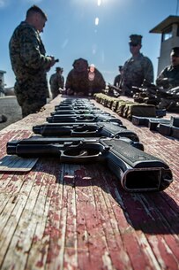 U.S. Marines with the 13th Marine Expeditionary Unit Command Element, await to be issued their M9 pistol before a pistol qualification range at Marine Corps Base Camp Pendleton, Nov. 26, 2019.