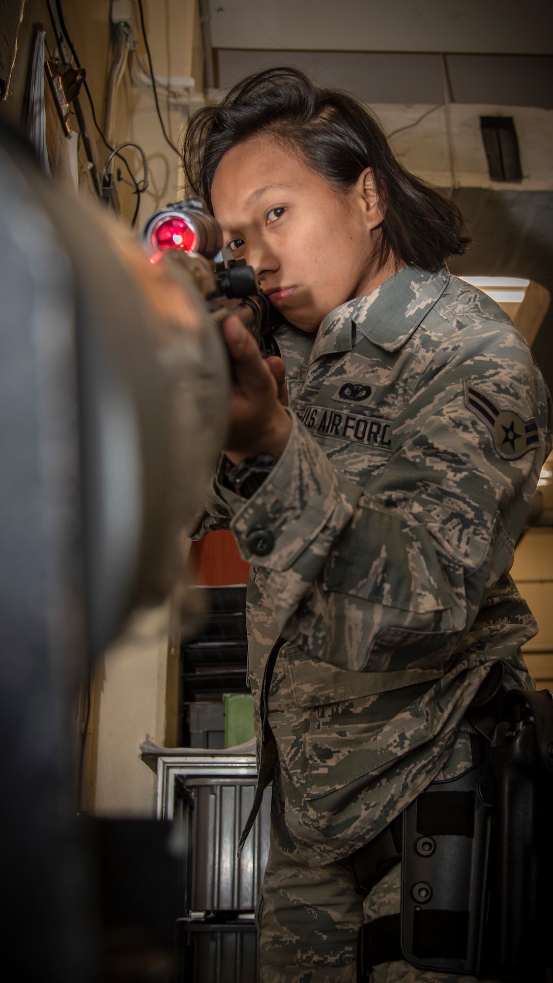 Airman 1st Class Jessica Carino, a 35th Security Forces Squadron armorer, ensures the M4 carbine assault rifle is clear and safe at Misawa Air Base, Japan, Dec. 18, 2019. Carino earned the Elizabeth N. Jacobson Award for Expeditionary Excellence, given for outstanding performance while deployed in Kunsan Air Base, South Korea. (U.S. Air Force photo by Airman 1st Class China M. Shock)