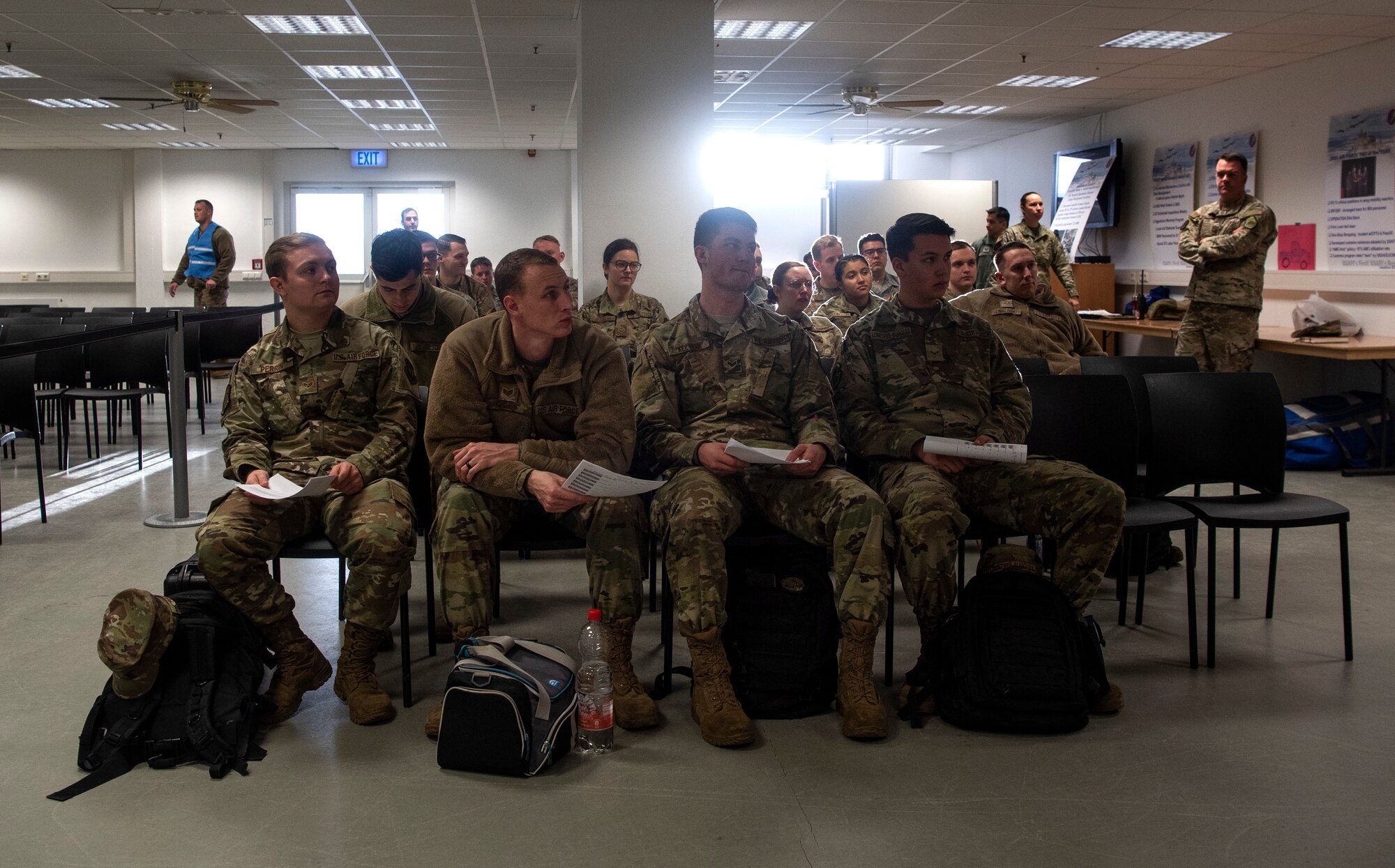 U.S. Air Force Airmen from the 52nd Fighter Wing hold orders while waiting to leave for a simulated deployment at Spangdahlem Air Base, Germany, Dec. 17, 2019. They participated in an Agile Combat Employment exercise, a developing concept of operations intended to ensure U.S. Air Forces in Europe are ready for potential contingencies. (U.S. Air Force photo by Airman 1st Class Valerie Seelye)