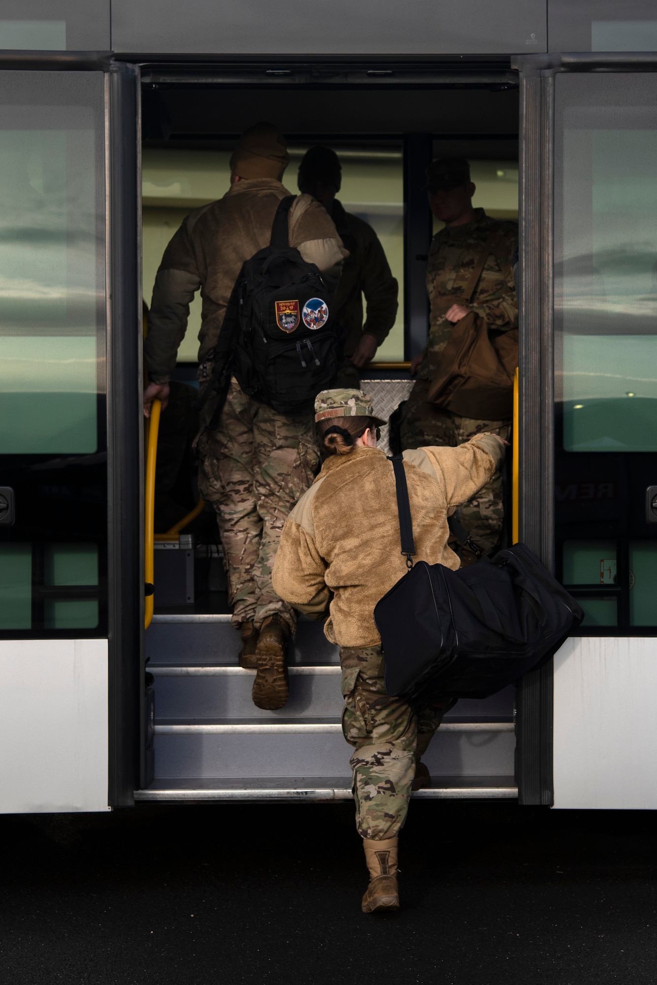 U.S. Air Force Airmen from the 52nd Fighter Wing board a bus during a simulated deployment at Spangdahlem Air Base, Germany, Dec. 17, 2019. The small team of Airmen conducted an Agile Combat Employment exercise on the Spangdahlem flightline in an effort to deter potential threats. Deployments and exercises demonstrate the U.S. military's contribution to regional security and reassure allies. (U.S. Air Force photo by Airman 1st Class Valerie Seelye)