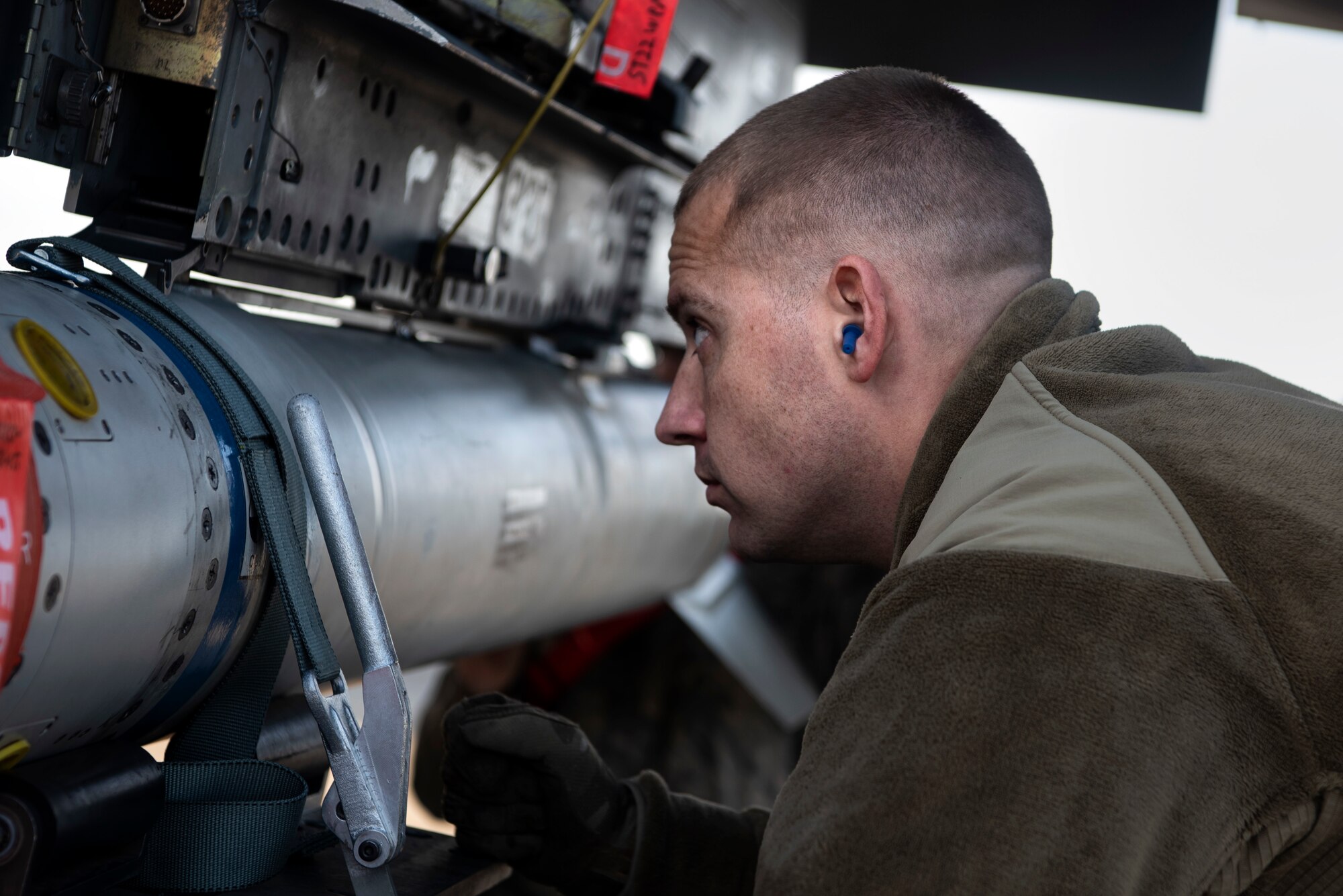 U.S. Air Force Tech. Sgt. Benjamin Angley, 52nd Aircraft Maintenance Squadron weapons load team chief, loads munitions onto an F-16 Fighting Falcon at Spangdahlem Air Base, Germany, Dec. 17, 2019. Angley participated in an Agile Combat Employment exercise to ensure U.S. Air Forces in Europe are ready for potential threats. (U.S. Air Force photo by Airman 1st Class Valerie Seelye)
