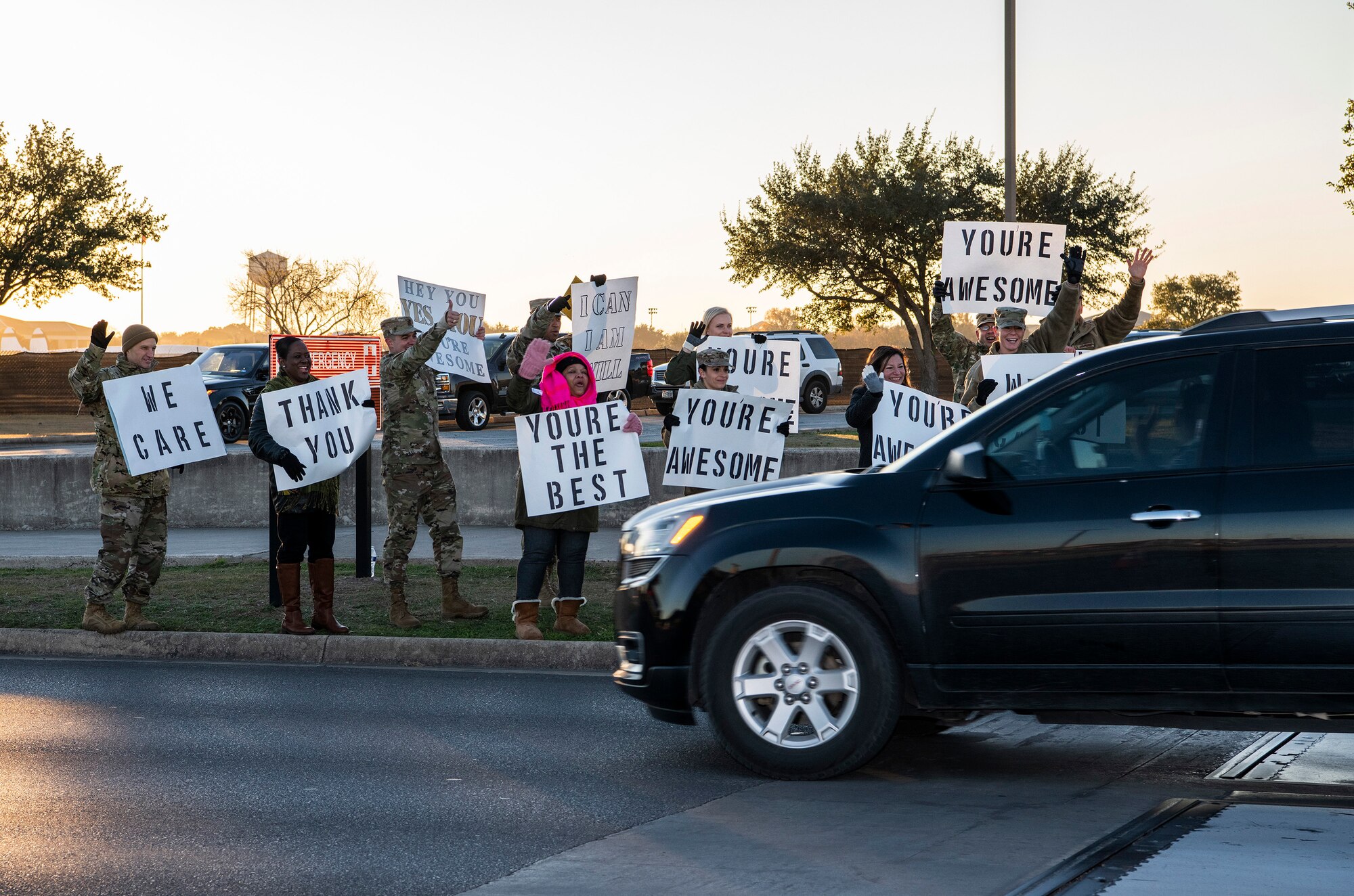 37th Training Wing military and civilian members hold positive messages of support at base gates during the morning inbound commute as part of their new initiative, “We Care,” at Joint Base San Antonio-Lackland, Texas, Dec. 18, 2019. The initiative involved 37th Training Wing military and civilian members spending the morning at various gates letting each person know that they stand together in support of those struggling with depression and thoughts of suicide by holding a positive message of support and handing out over 400 candy canes. If you are struggling with thoughts of suicide, please go directly to the Mental Health Clinic or to your closest Emergency Room. You can also reach the National Suicide Prevention Lifeline at 1-800-273-8255.