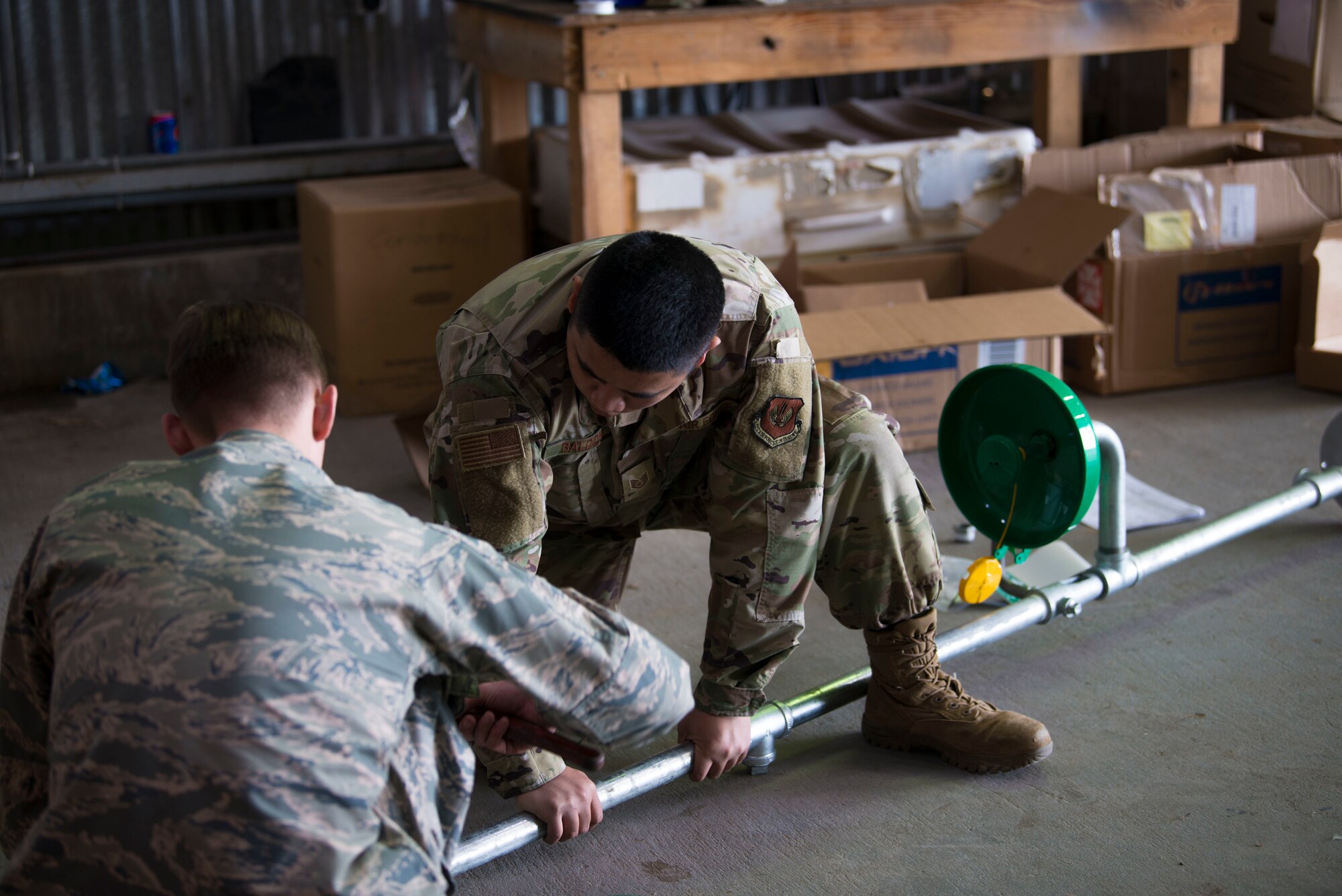 U.S. Air Force Staff Sgt. Mark Baldon, right, 786th Civil Engineer Squadron water and fuels systems craftsman, and Airman 1st Class Daniel Shadi, 786th CES water and fuels systems journeyman, construct an eye-wash station on Morón Air Base, Spain, Dec. 12, 2019. (U.S. Air Force photo by Senior Airman Sara Voigt)