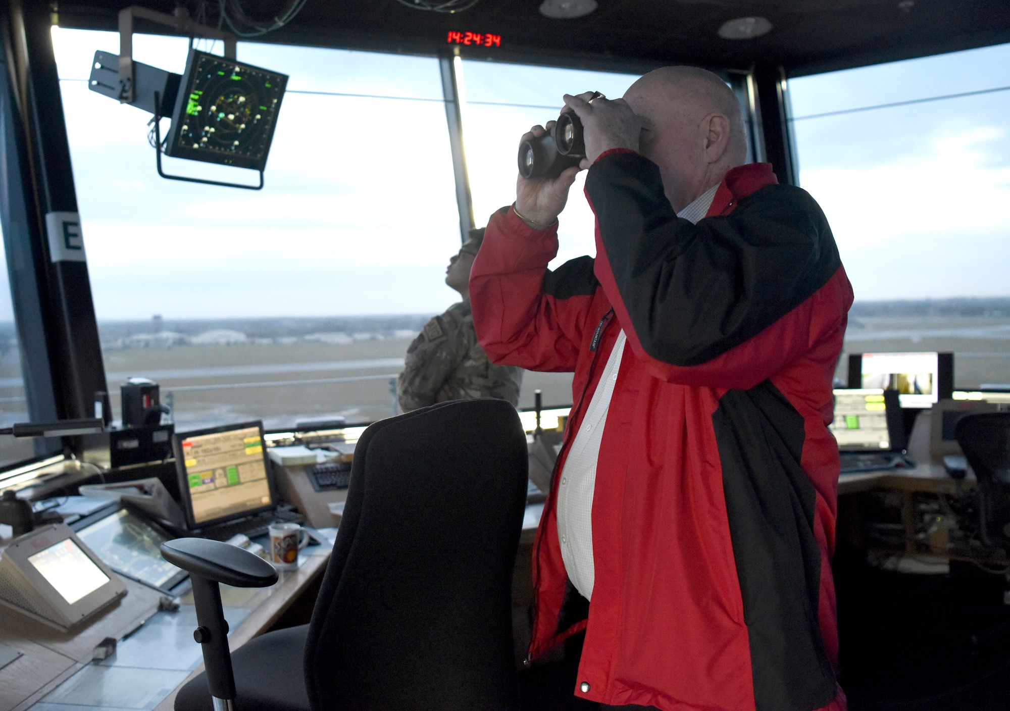 William “Doc” Schmitz, Commander-in-Chief for Veterans of Foreign Wars, peers through binoculars while touring the RAF Mildenhall control tower during a visit to base Dec. 18, 2019. Schmitz spoke with Airmen and toured Mildenhall to learn of the base’s mission and quality of life programs. (U.S. Air Force photo by Senior Airman Brandon Esau)