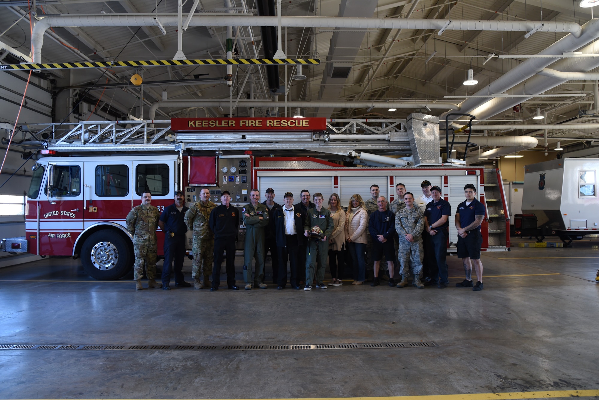 Honorary 2nd Lt. Charles “Payton” Burge (center) poses for a photo with family and Airmen of the base fire department, during the Pilot for a Day program Dec. 19, Keesler Air Force Base, Miss. The 403rd Wing collaborated with Make A Wish Mississippi who selects the children who will participate in the Program. (U.S. Air Force photo by Lt. Col. Marnee A.C. Losurdo)