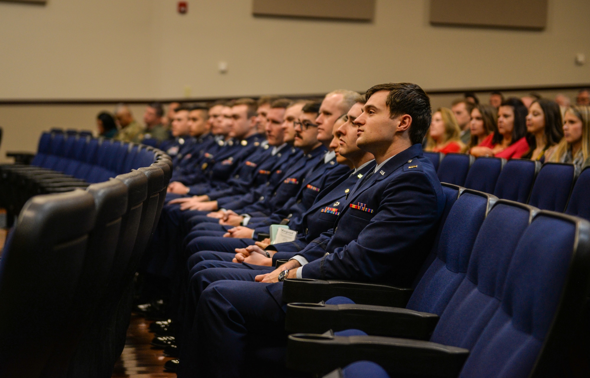 Specialized Undergraduate Pilot Training Class 20-04/05 listens to a speech at their graduation ceremony, Dec. 13, 2019, at Columbus Air Force Base, Miss. To graduate from SUPT at Columbus AFB, students must conduct over a year of pilot training. (U.S. Air Force photo by Airman Davis Donaldson)