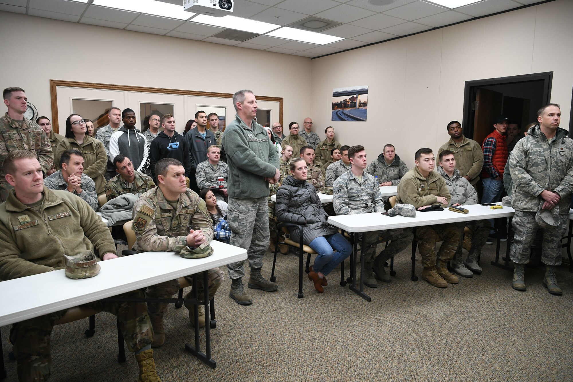 Airmen from Hill Air Force Base, Utah, listen to a brief at Utah Foster Care Foundation in Ogden before delivering gifts to foster children Dec. 18, 2019, as part of a volunteer effort called Santa Brigade.  Around 85 Airmen from various commands played Santa for the day delivering 537 gifts to over 140 foster care families around Northern Utah. (U.S. Air Force photo by Cynthia Griggs)
