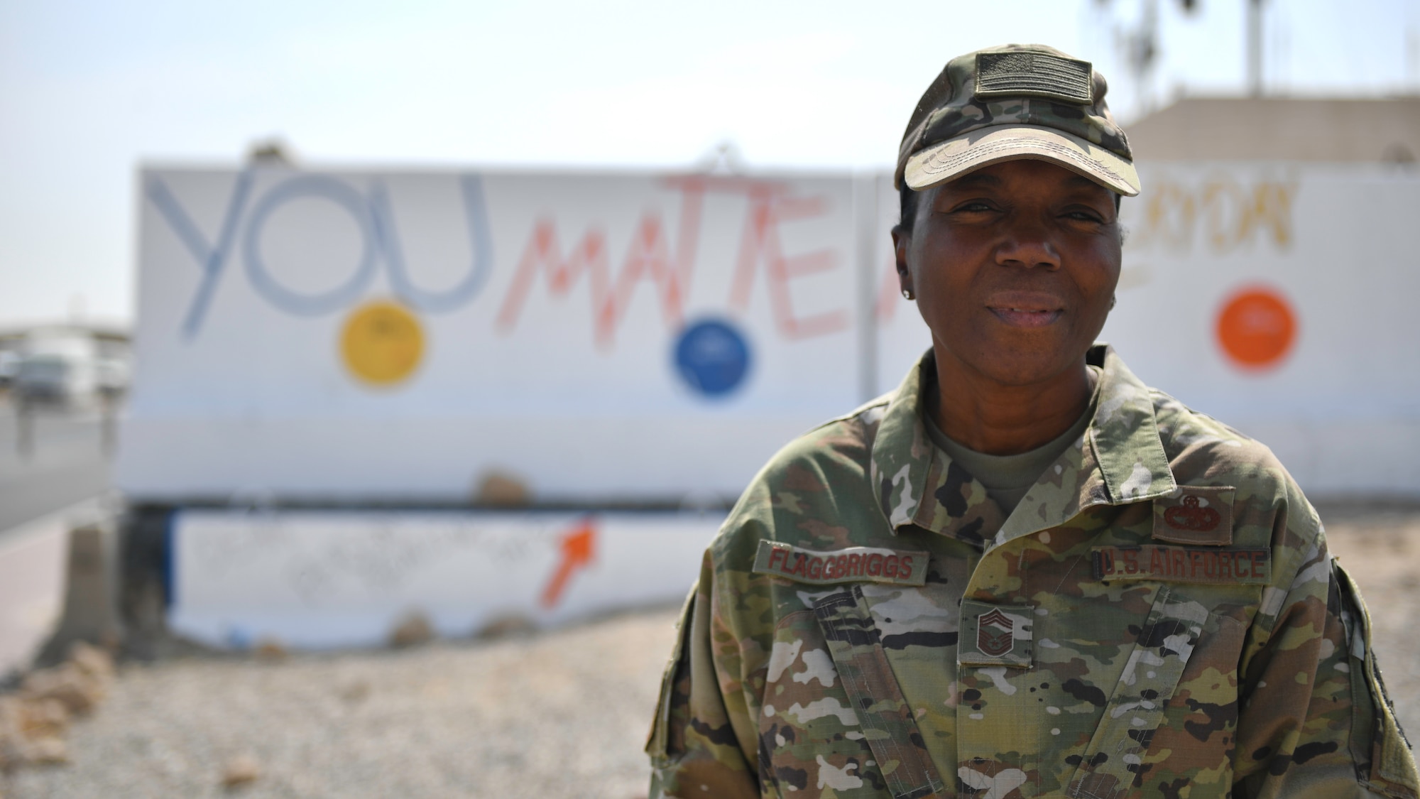 Chief Master Sgt. Sabrena Flagg-Briggs takes a photo in front of the "You Matter" wall. (U.S. Air Force photo by Staff Sgt. Mozer O. Da Cunha)