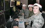 Airmen at the Eastern Air Defense Sector (EADS) train in preparation for Santa’s Christmas Eve flight at EADS headquarters in Rome, N.Y., Dec. 17, 2019. Pictured are, from right,  Senior Airman Timothy Destito of the New York Air National Guard; Capt. John Byeon, Royal Canadian Air Force, and Capt. Sarah Atherton, New York Air National Guard. Atherton and Destito are members of the 224th Air Defense Squadron and  Byeon is a member of the Canadian Detachment at EADS.