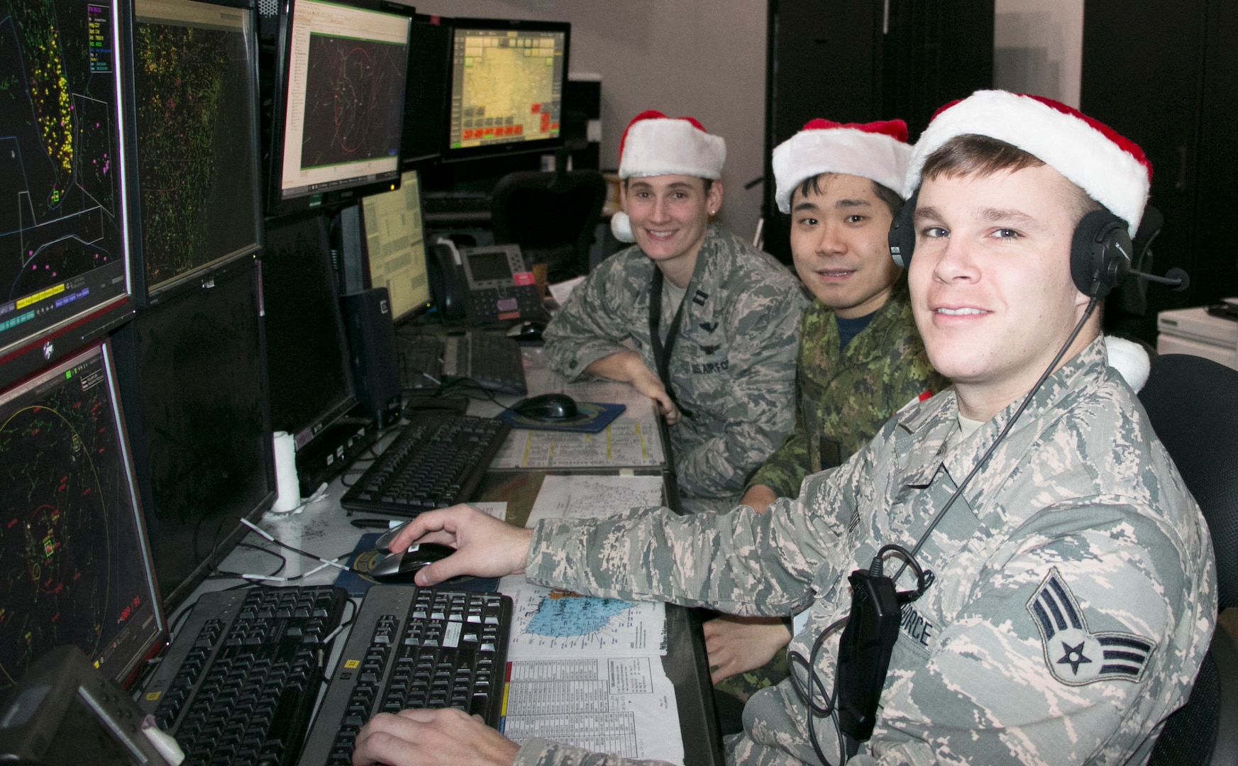 Airmen at the Eastern Air Defense Sector (EADS) train in preparation for Santa’s Christmas Eve flight at EADS headquarters in Rome, N.Y., Dec. 17, 2019. Pictured are, from right,  Senior Airman Timothy Destito of the New York Air National Guard; Capt. John Byeon, Royal Canadian Air Force, and Capt. Sarah Atherton, New York Air National Guard. Atherton and Destito are members of the 224th Air Defense Squadron and  Byeon is a member of the Canadian Detachment at EADS.