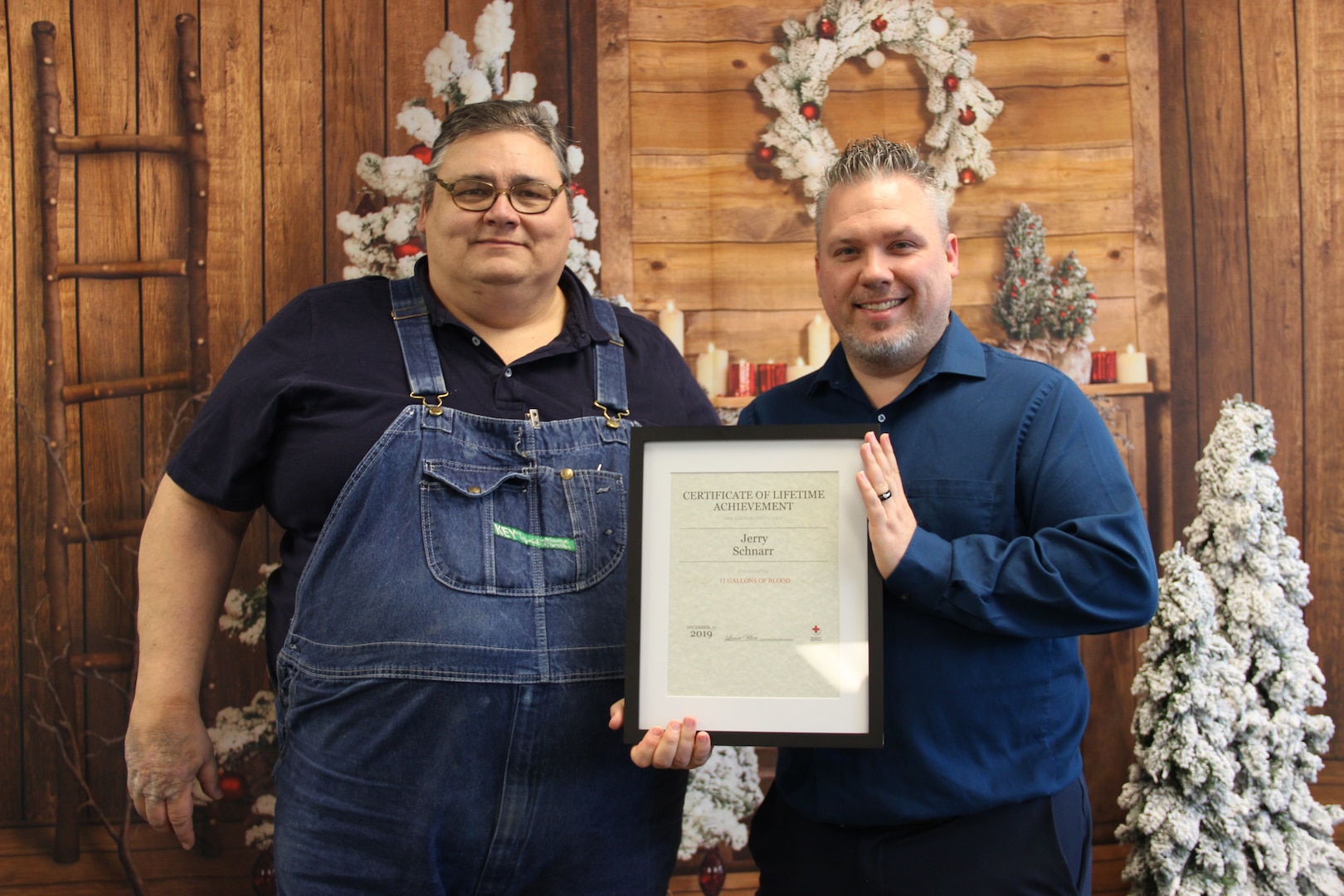 NSWC Crane Employee Jerry Schnarr (left) was recognized by the Red Cross's Lance White (right) for donating more than 11 gallons of blood during his lifetime so far