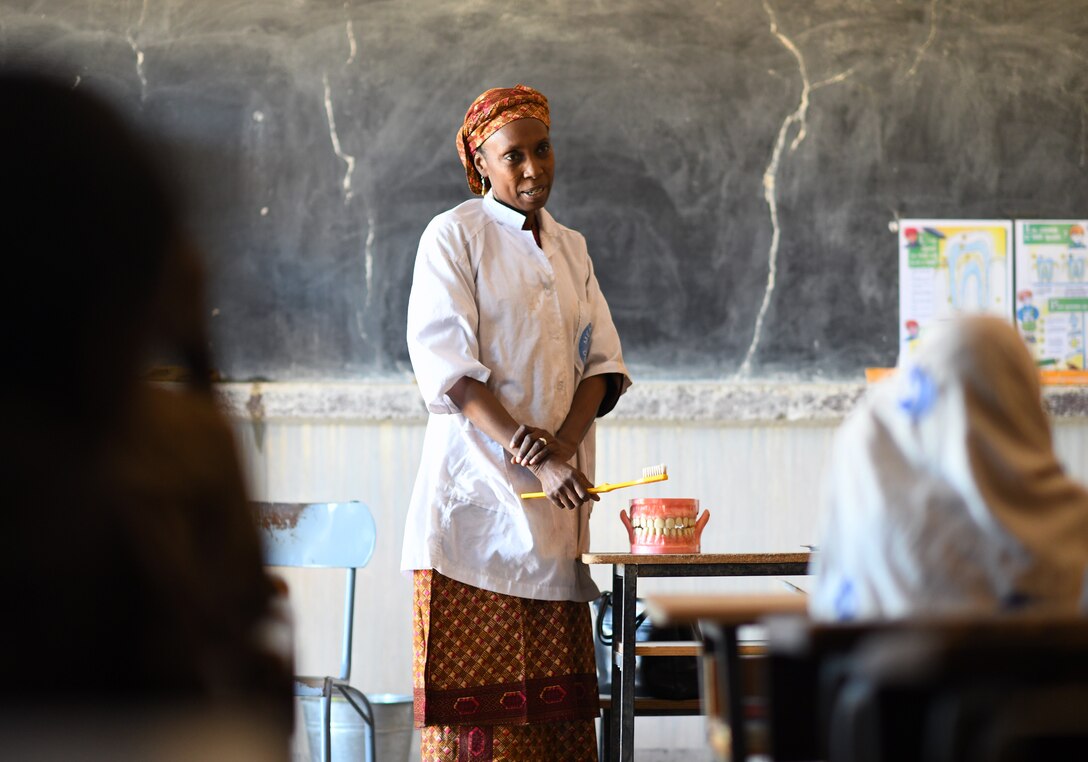 Dr. Mahaman Aicha, an Agadez city dentist, teaches a dental hygiene course to local school children in the village of Tsakatalam, Niger, Dec. 14, 2019. The U.S. Army 443rd Civil Affairs Battalion Civil Affairs Team 219 deployed to Nigerien Air Base 201 partnered with the dentist to teach the Tsakatalam Primary School students for the first time how to properly brush and floss their teeth and the importance of good oral health. (U.S. Air Force photo by Staff Sgt. Alex Fox Echols III)