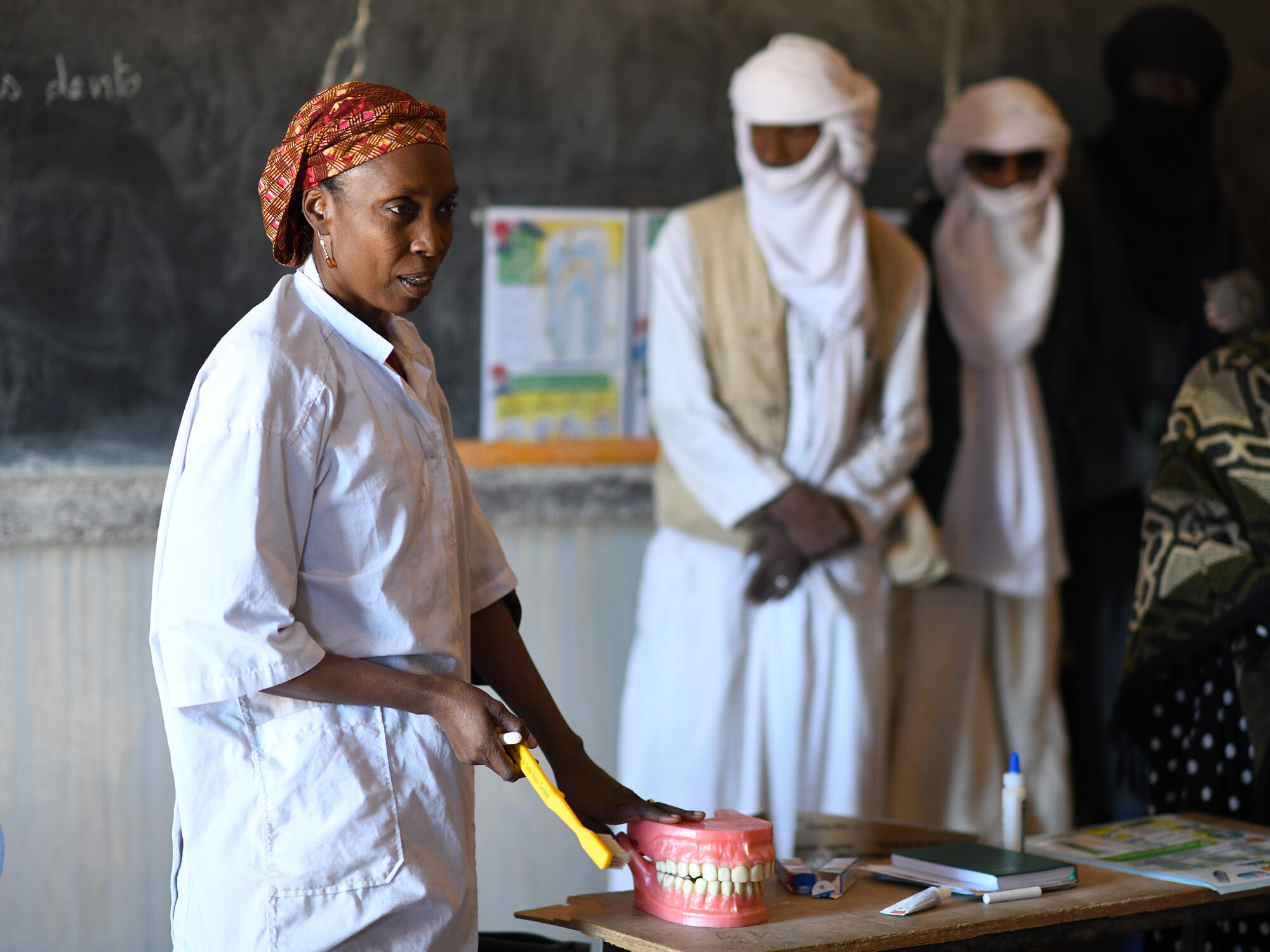 Dr. Mahaman Aicha, an Agadez city dentist, teaches a dental hygiene course to local school children in the village of Tsakatalam, Niger, Dec. 14, 2019. The U.S. Army 443rd Civil Affairs Battalion Civil Affairs Team 219 deployed to Nigerien Air Base 201 partnered with the dentist to teach the Tsakatalam Primary School students for the first time how to properly brush and floss their teeth and the importance of good oral health. (U.S. Air Force photo by Staff Sgt. Alex Fox Echols III)
