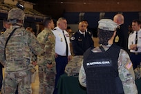 Members of the 372nd Military Police Battalion, known as the Red Hand, brief Maj. Gen. Olivier Kim, Chief of the French Gendarmerie Reserves Command, on their crucial role in conducting traffic control, corrections, security and mobility support, especially during National Special Security Events.