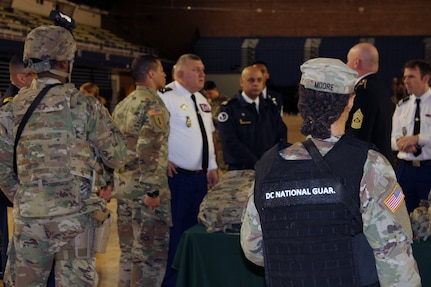 Members of the 372nd Military Police Battalion, known as the Red Hand, brief Maj. Gen. Olivier Kim, Chief of the French Gendarmerie Reserves Command, on their crucial role in conducting traffic control, corrections, security and mobility support, especially during National Special Security Events.