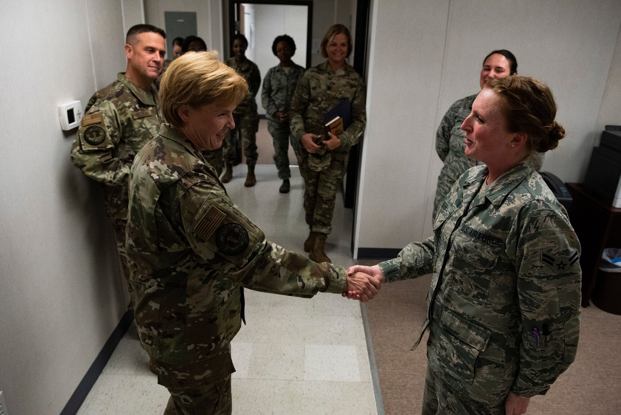 U.S. Air Force Brig. Gen. Sharon Bannister, Air Combat Command Surgeon General, left, coins Airman 1st Class Brittani Wattes, 325th Operational Medical Readiness Squadron family medicine technician, at Tyndall Air Force Base, Florida, Dec. 18, 2019. Bannister coined Watts for the airman's positive attitude, dedication to performing tasks and completing upgrade training in compliance with U.S. Air Force standards. (U.S. Air Force photo by Staff Sgt Magen M. Reeves)