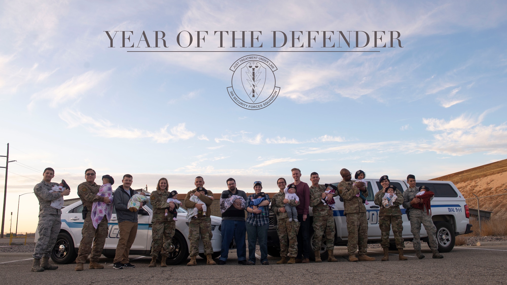 366th Security Forces Squadron members hold their children Nov. 20, 2019 at Mountain Home Air Force Base, Idaho. The 366th SFS had a total of 21 babies this year. (U.S. Air Force photo by Airman Natalie Rubenak)