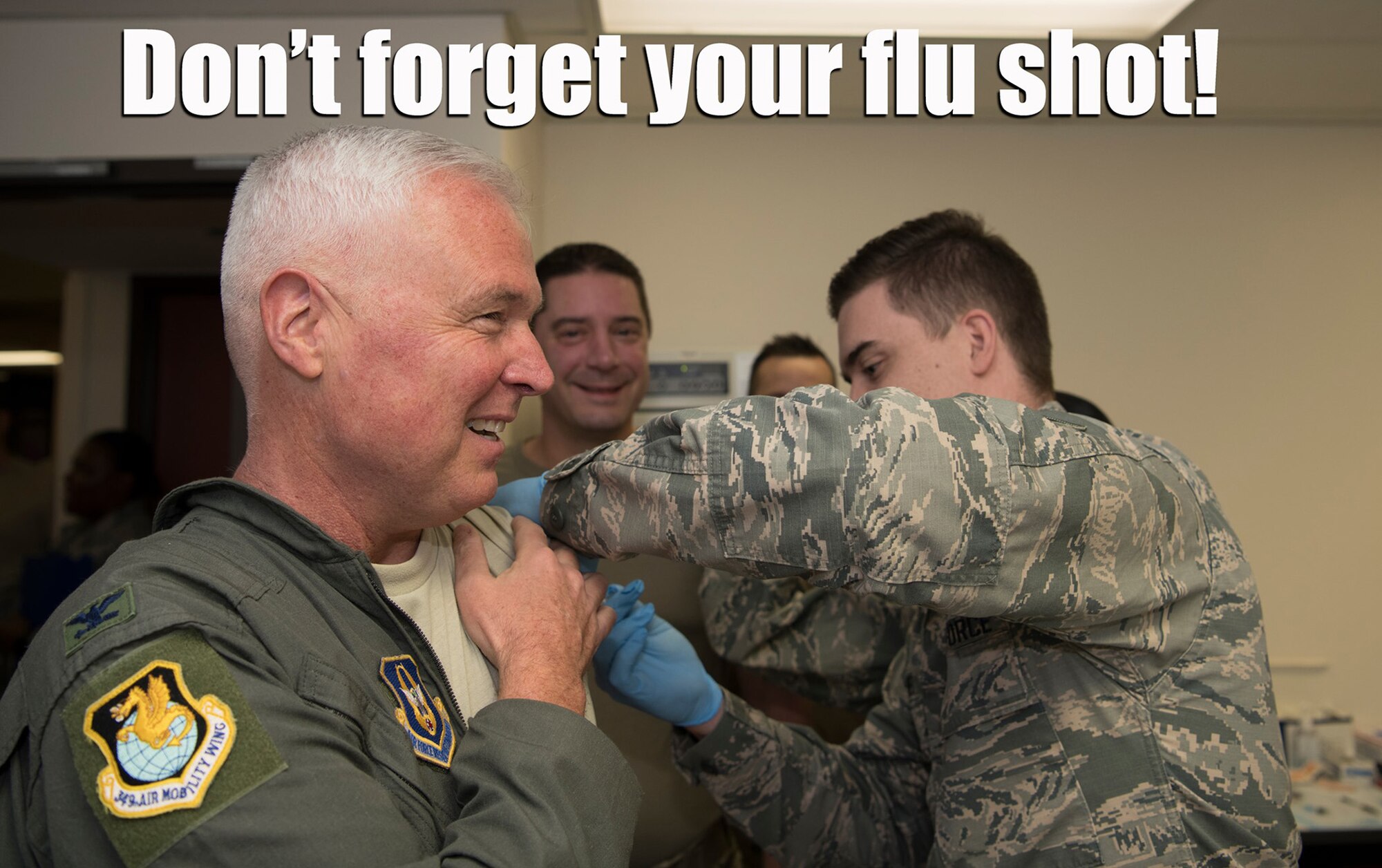 Col. Scott L. McLaughlin, Commander, 349th Air Mobility Wing Commander and Col. Charles J. Metzgar, Vice Commander, 349th AMW, Travis Air Force Base, Calif., both step-up and get their flu shots during a recent UTA.