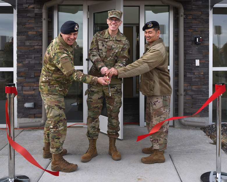 From left to right, Maj. Joseph Farinash, 460th Security Forces Squadron commander, Col. Trevor Wentlandt, 460th Mission Support Group commander, and Chief Master Sgt. Max Van Ausdal, 460th SFS security forces manager, cut the ribbon to signify the opening of the 460th Security Forces Combat Arms Training and Maintenance Facility at Buckley Air Force Base, Colo., Dec 19, 2019.