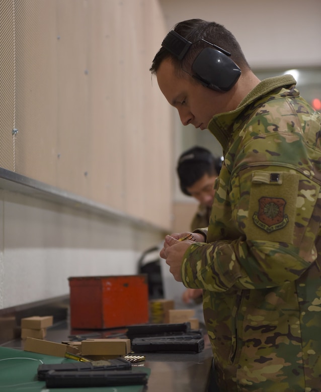 Major. Joseph Farinash, 460th Security Forces Squadron commander, loads ammunition into a clip at the 460th Security Forces Combat Arms Training and Maintenance Facility at Buckley Air Force Base, Colo., Dec. 19, 2019.