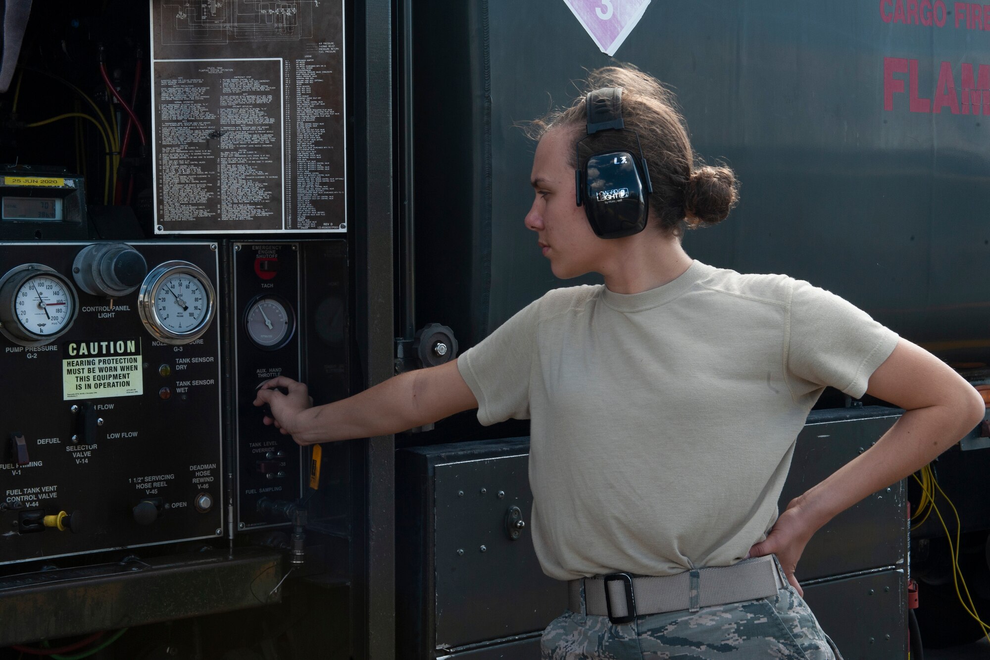 Photo of an Airman monitoring gauges on a fuel truck
