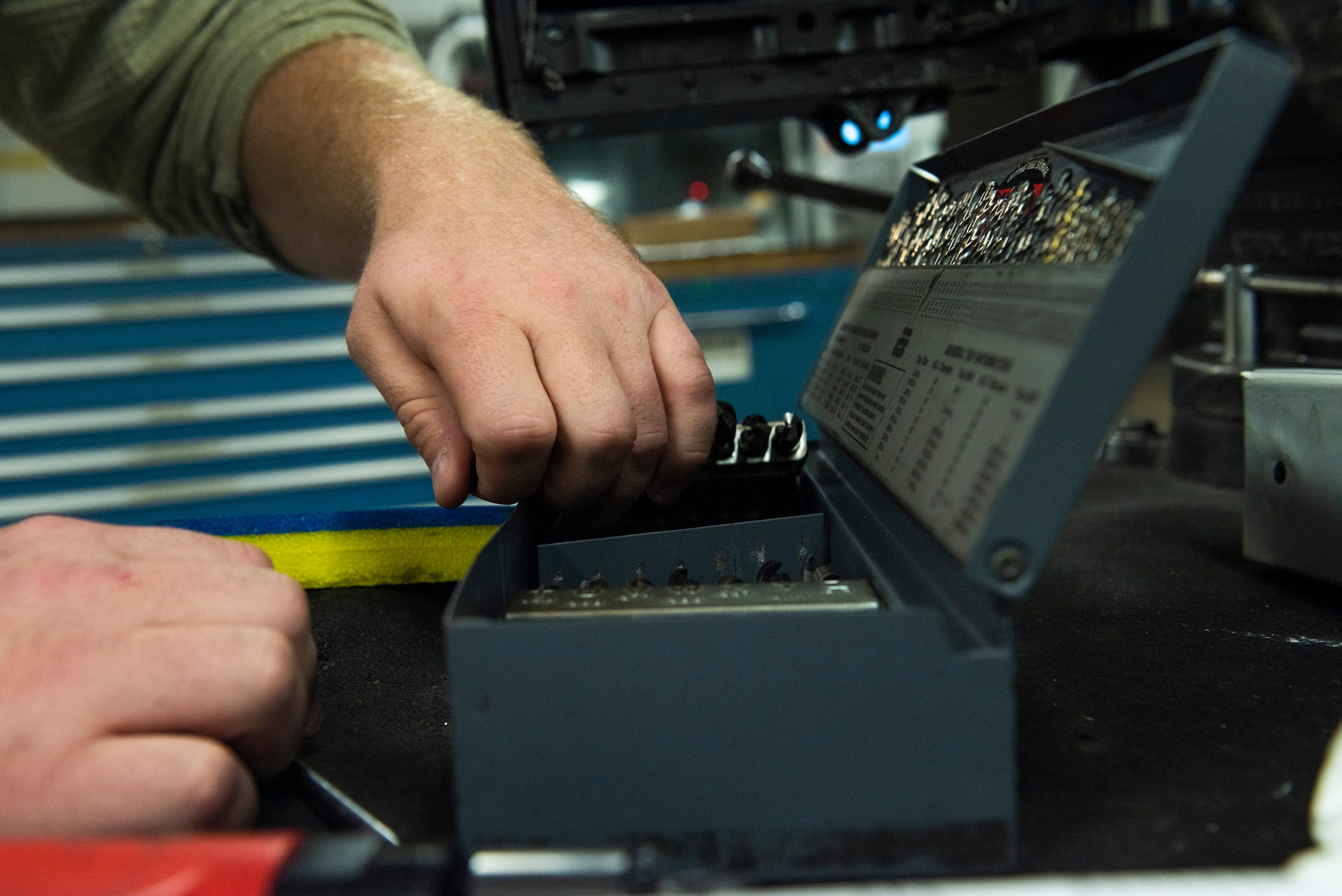 A photo of an Airman taking tools out of a toolbox.