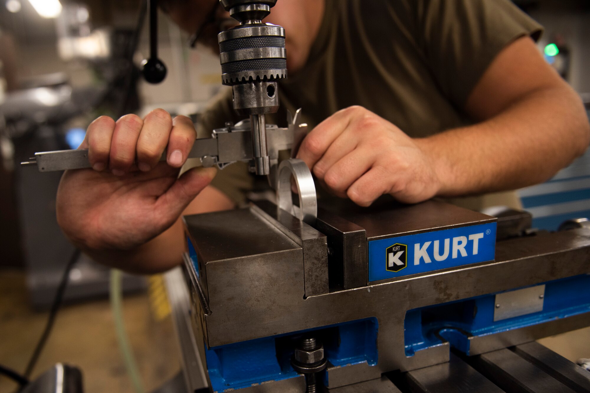 A photo of an Airman measuring a bushing