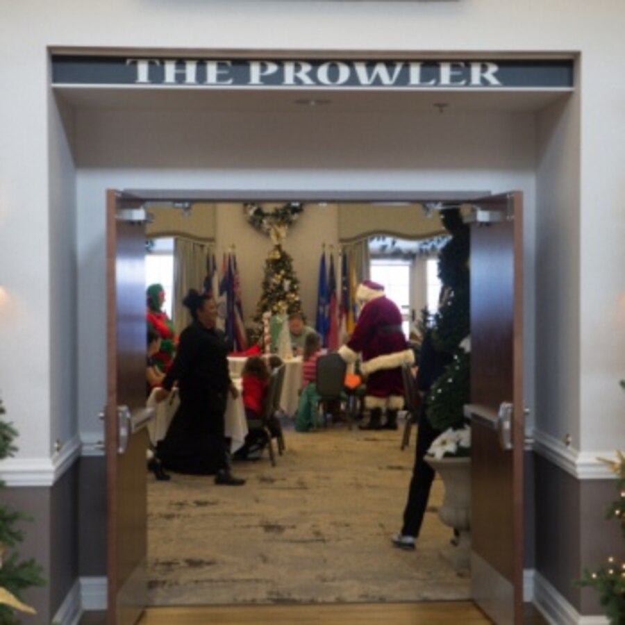 Santa Claus greets a family during a Marine Corps Community Services Cherry Point Breakfast with Santa event at Marine Corps Air Station Cherry Point, North Carolina, Dec. 7, 2019. The event featured a free, all you can eat breakfast buffet, a letters to Santa mailbox, free toys, an open bar for adults, and gave children the opportunity to tell Santa what they want for Christmas. (U.S. Marine Corps photo by Lance Cpl. Michael Neuenhoff)