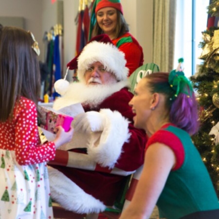 A child receives an early Christmas present from Santa Claus and his elves during a Breakfast with Santa event at Marine Corps Air Station Cherry Point, North Carolina, Dec. 7, 2019. The event featured a free, all you can eat breakfast buffet, a letters to Santa mailbox, free toys, an open bar for adults, and gave children the opportunity to tell Santa what they want for Christmas. Breakfast with Santa was hosted by Marine Corps Community Services Cherry Point. (U.S. Marine Corps photo by Lance Cpl. Michael Neuenhoff)