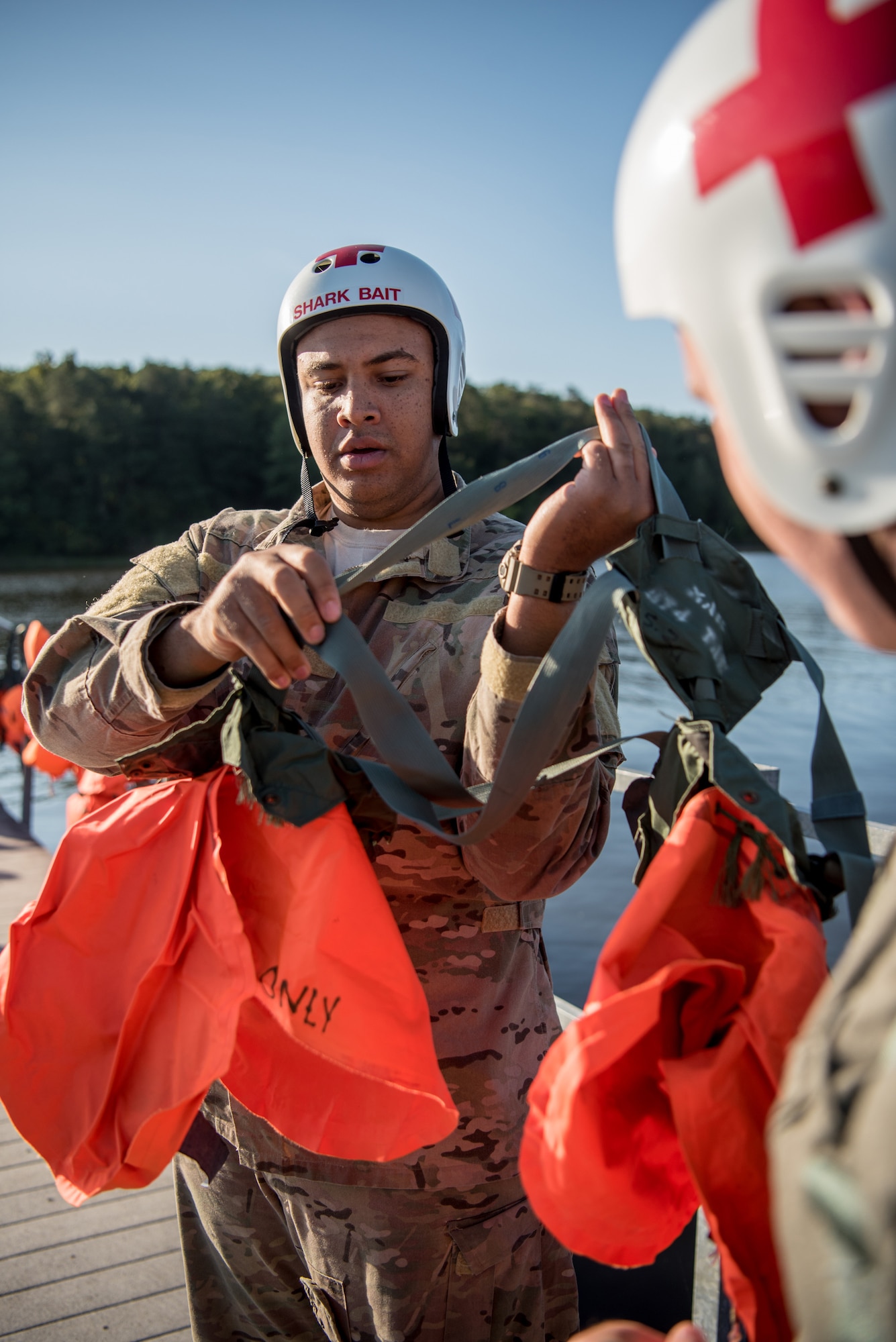 Staff Sgt. Kierre Brown, a loadmaster for the Kentucky Air National Guard’s 165th Airlift Squadron, straps on a parachute harness prior to water survival training at Camp Crooked Creek in Shepherdsville, Ky., Sept. 14, 2019. The training also covered land survival techniques and orienteering. (U.S. Air National Guard photo by Staff Sgt. Joshua Horton)
