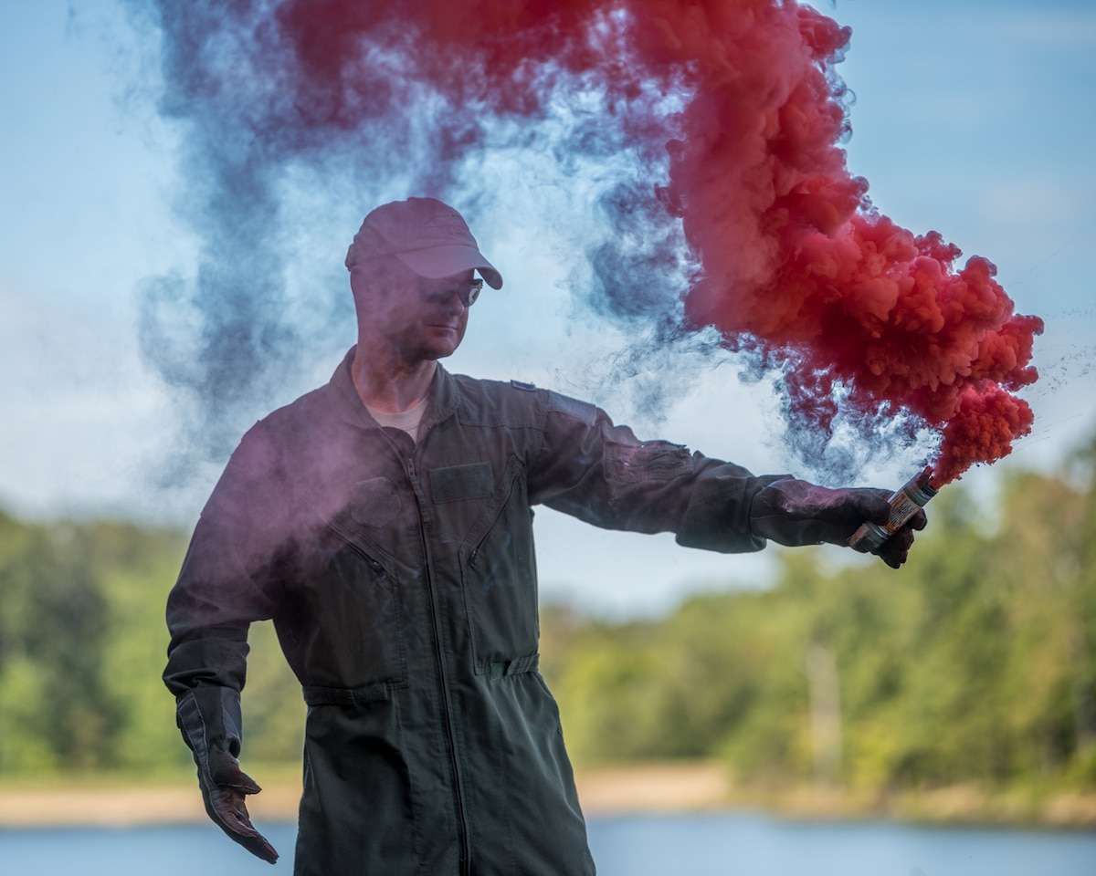 Lt. Col. James White, a C-130 pilot for the Kentucky Air National Guard’s 165th Airlift Squadron, uses a MK-124 day/night signaling flare during survival training at Camp Crooked Creek in Shepherdsville, Ky., Sept. 14, 2019. More than 60 aircrew members practiced land- and water-survival training here Sept. 13-15. (U.S. Air National Guard photo by Staff Sgt. Joshua Horton)