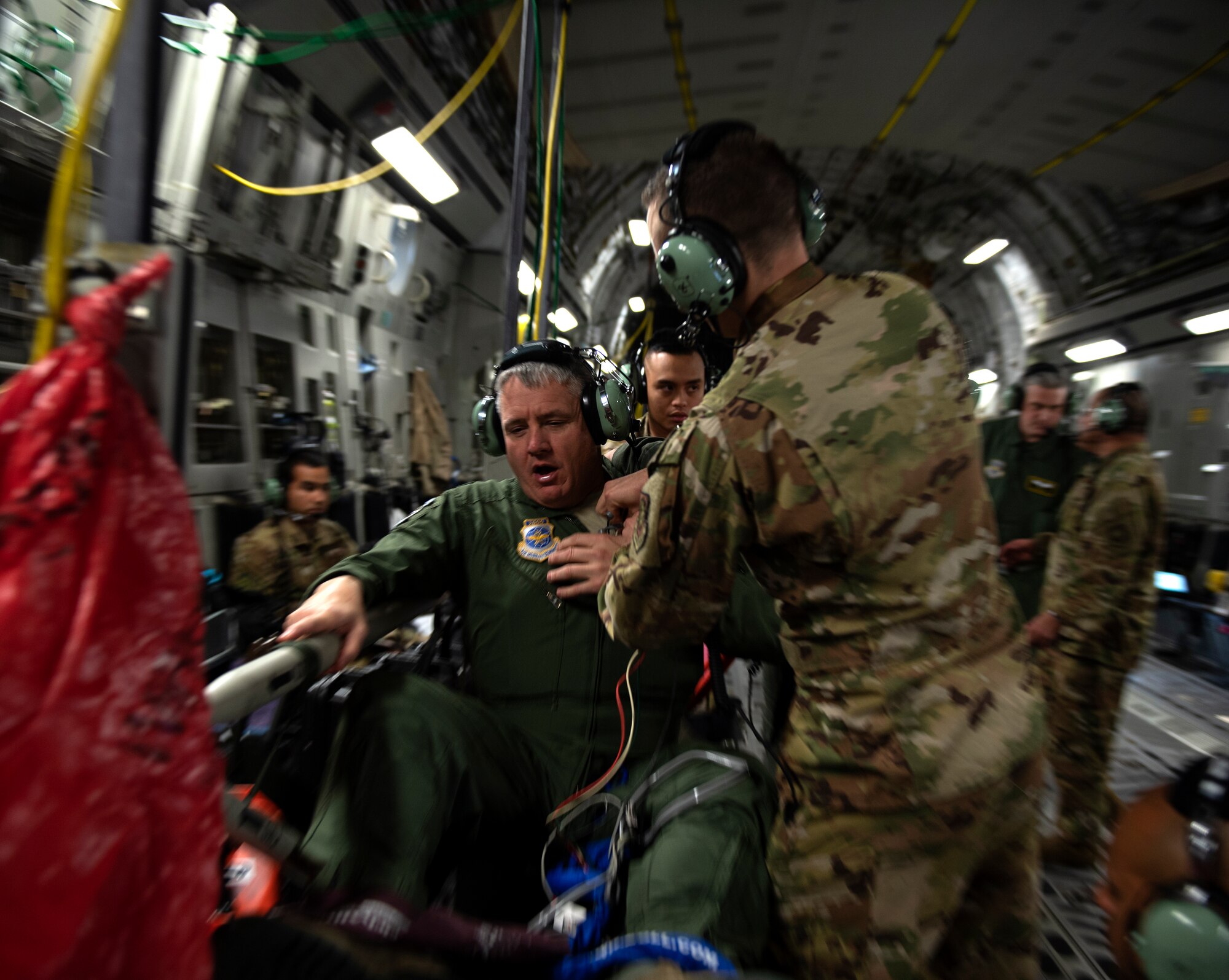 photos of Airmen practicing aeromedical evacuation on a C-17 Globemaster III from Travis AFB, California.