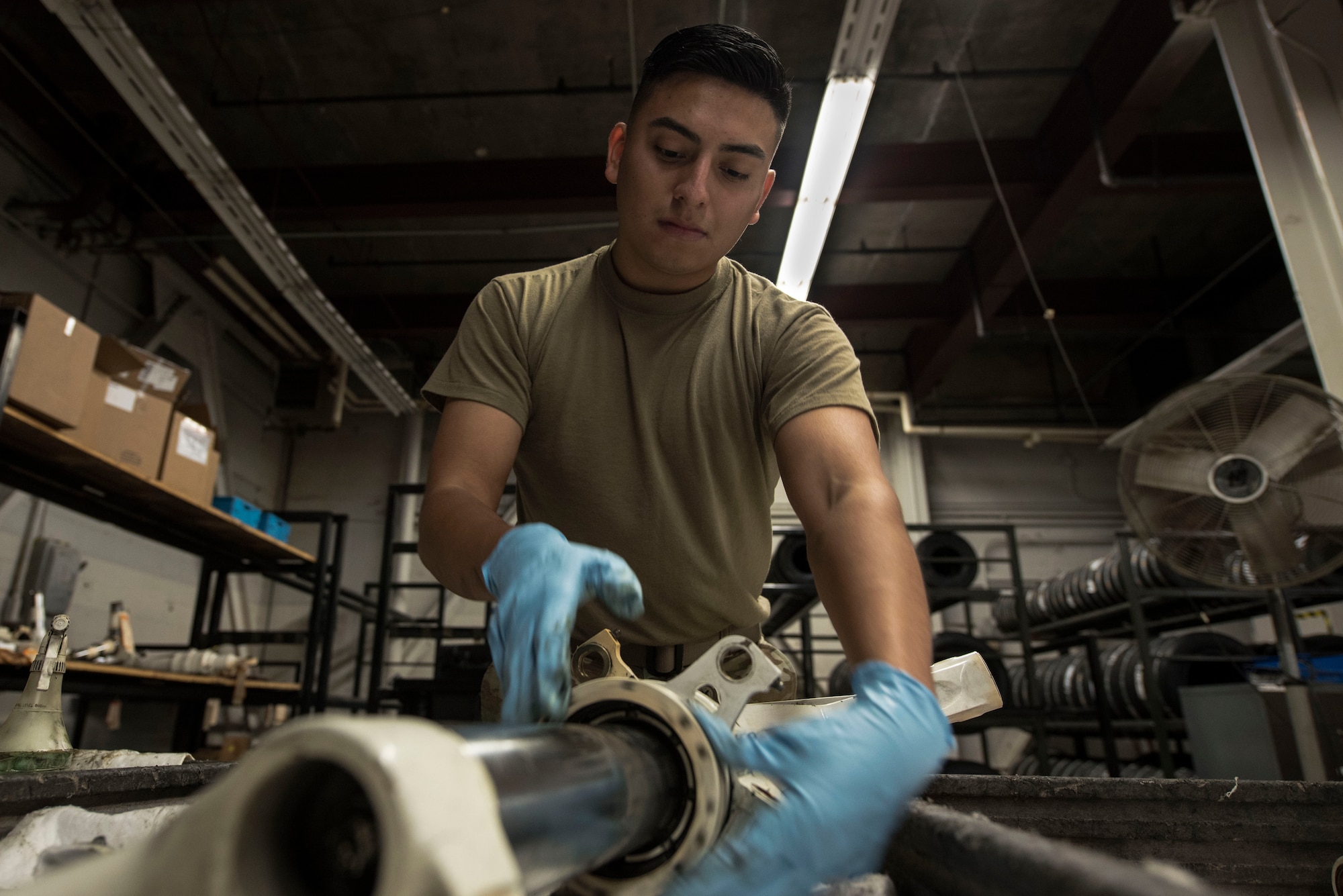 Airman cleans aircraft part
