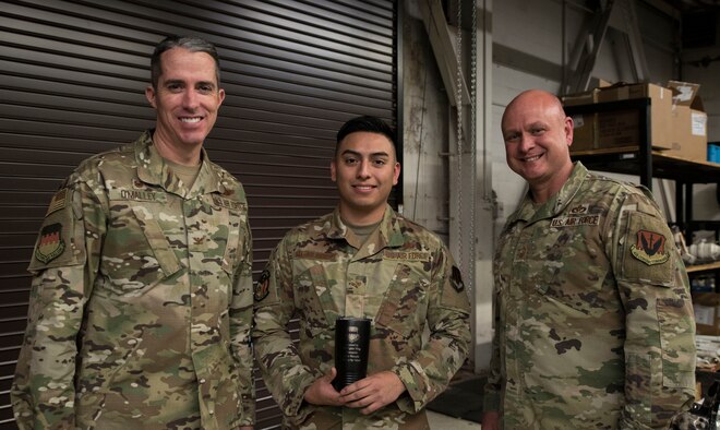 Airman stands with leadership