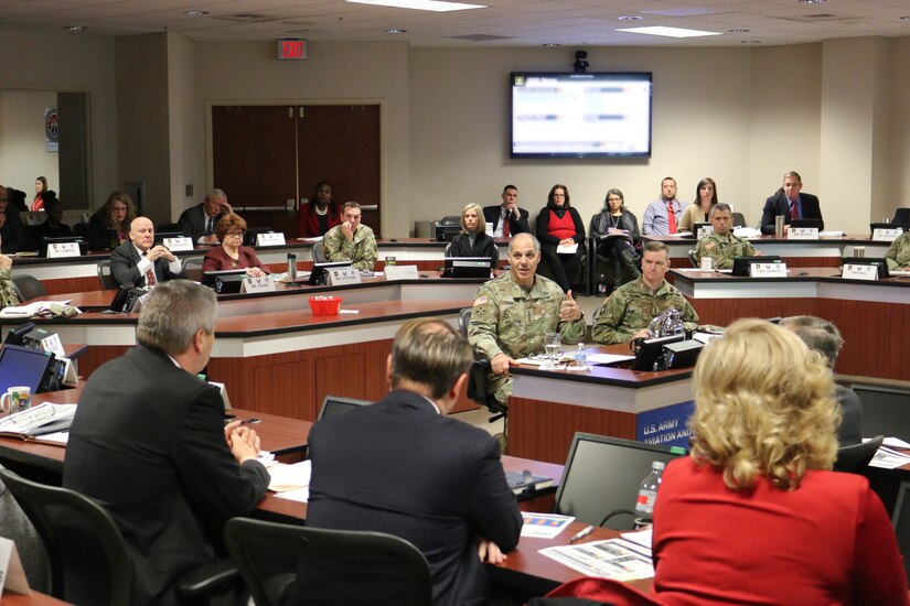 Gen. Gus Perna, commander of the Army Materiel Command, and Maj. Gen. Todd Royar, commander of the U.S. Army Aviation and Missile Command,  receive a briefing from AMCOM Logistics Director Craig Northridge during the Dec. 18 Quarterly Update.
