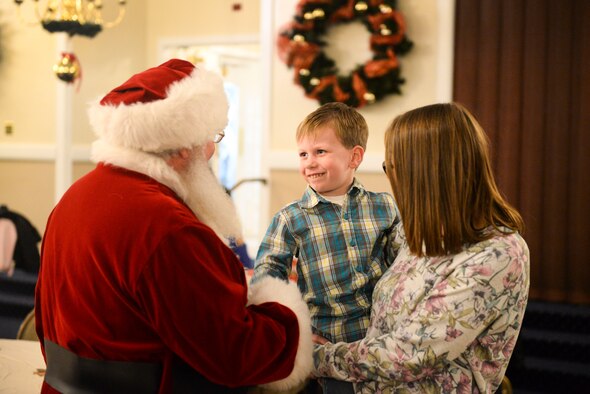Killian Kimball, an Air Force family member, smiles as he meets Santa Claus at the 2019 Hearts Apart Holiday Event at Hanscom Air Force Base, Mass., Dec. 18. The Hearts Apart program offers support and activities for families while their loved ones are serving abroad. (U.S. Air Force photo by Lauren Russell)