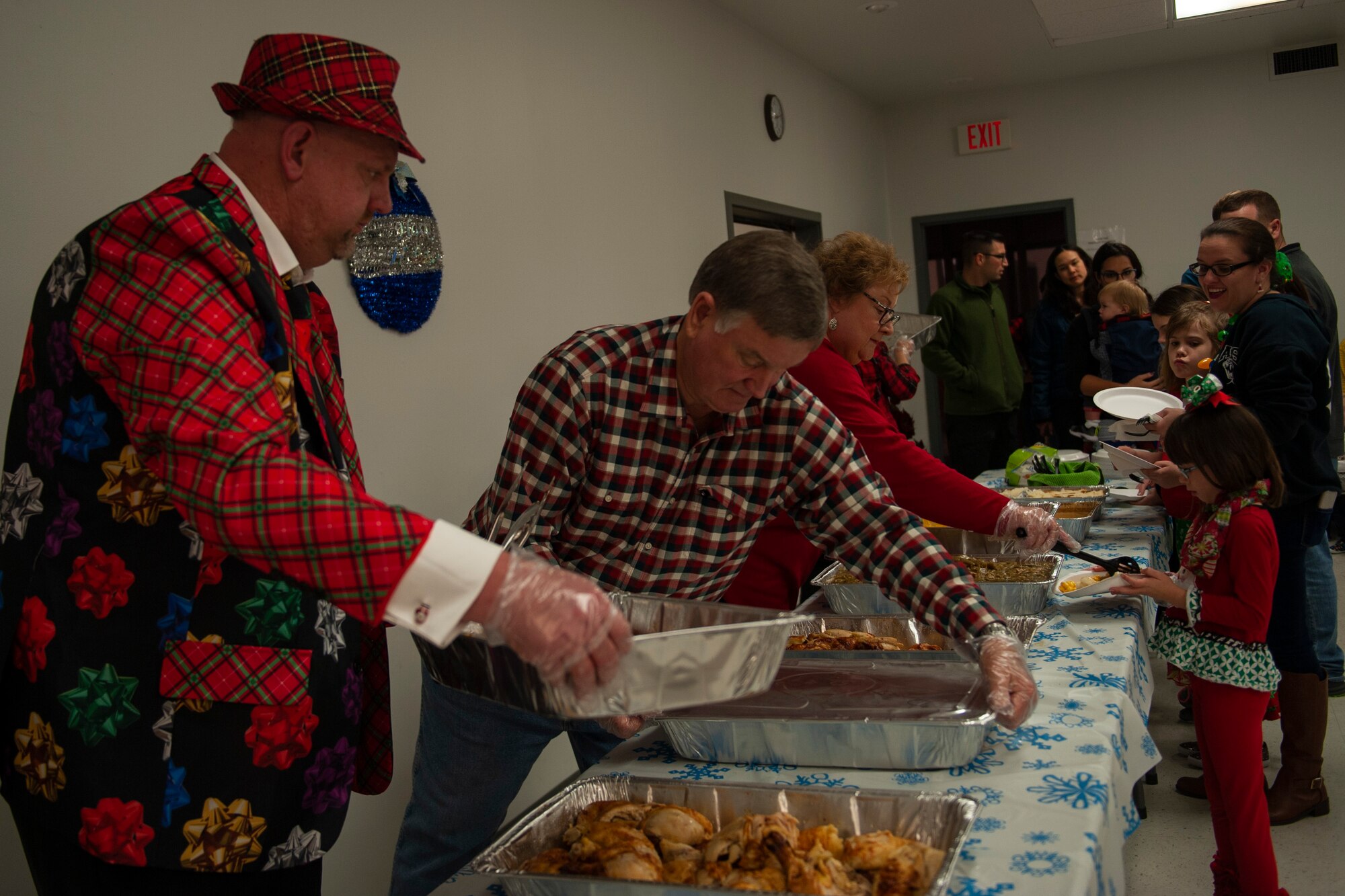 A photo of volunteers serving food at the Holiday Dinner