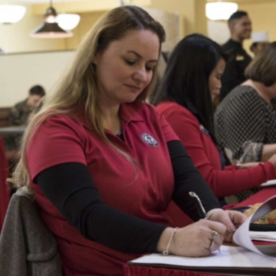 Veronica Duplessis, a case worker with the Navy Marine Corps Relief Society, rates a participant during a Chef of the Quarter competition at Marine Corps Air Station Cherry Point, North Carolina, Dec. 13, 2019. The contestants were judged on a variety of things including presentation and taste. The winner of this event will go on to compete in the Chef of the Year competition, going against the other Chef of the Quarter winners for the chance to win top chef. (U.S. Marine Corps photo by Lance Cpl. Jacob Bertram)